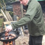 Frying bacon on a burning stump